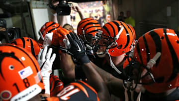 Nov 5, 2015; Cincinnati, OH, USA; Cincinnati Bengals quarterback Andy Dalton (right) talks with teammates in a huddle before taking the field prior to the game against the Cleveland Browns at Paul Brown Stadium. Mandatory Credit: Aaron Doster-USA TODAY Sports