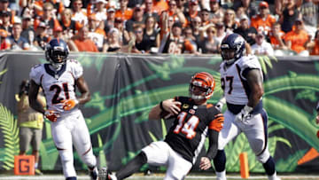 Sep 25, 2016; Cincinnati, OH, USA; Cincinnati Bengals quarterback Andy Dalton (14) slides for a first down against Denver Broncos cornerback Aqib Talib (21) and defensive lineman Billy Winn (97) in the second half at Paul Brown Stadium. Denver defeated the Cincinnati 29-17. Mandatory Credit: Mark Zerof-USA TODAY Sports