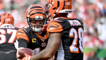 CINCINNATI, OH - SEPTEMBER 15: Andy Dalton #14 of the Cincinnati Bengals hands off the ball to Joe Mixon #28 of the Cincinnati Bengals during the fourth quarter of the game against the San Francisco 49ers at Paul Brown Stadium on September 15, 2019 in Cincinnati, Ohio. (Photo by Bobby Ellis/Getty Images)