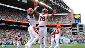 SEATTLE, WASHINGTON - SEPTEMBER 08: John Ross #11 (L) celebrates with Joe Mixon #28 of the Cincinnati Bengals after scoring a 33 yard touchdown pass against the Seattle Seahawks in the second quarter during their game at CenturyLink Field on September 08, 2019 in Seattle, Washington. (Photo by Abbie Parr/Getty Images)