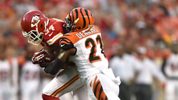 KANSAS CITY, MO - AUGUST 07: Knile Davis #34 of the Kansas City Chiefs is tackled by Darqueze Dennard #21 of the Cincinnati Bengals at Arrowhead Stadium on August 7, 2014 in Kansas City, Missouri. (Photo by Peter Aiken/Getty Images)