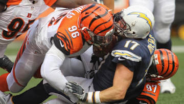 CINCINNATI, OH - SEPTEMBER 20: Carlos Dunlap #96 of the Cincinnati Bengals makes the tackle on Philip Rivers #17 of the San Diego Chargers during their game at Paul Brown Stadium on September 20, 2015 in Cincinnati, Ohio. The Bengals defeated the Chargers 24-19. (Photo by John Grieshop/Getty Images)