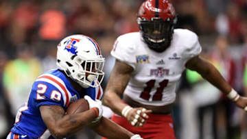 NEW ORLEANS, LA - DECEMBER 19: Kenneth Dixon #28 of the Louisiana Tech Bulldogs is pursued by Ja'Von Rolland-Jones #11 of the Arkansas State Red Wolves during the third quarter of the R+L Carriers New Orleans Bowl at the Mercedes-Benz Superdome on December 19, 2015 in New Orleans, Louisiana. (Photo by Stacy Revere/Getty Images)