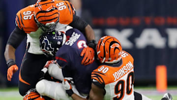 HOUSTON, TX - DECEMBER 24: Tom Savage #3 of the Houston Texans is tackled behind the line of scrimmage by Wallace Gilberry #95, Michael Johnson #90, and Carlos Dunlap #96 of the Cincinnati Bengals in the first quarter at NRG Stadium on December 24, 2016 in Houston, Texas. (Photo by Tim Warner/Getty Images)