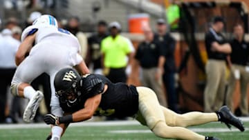 WINSTON SALEM, NC - AUGUST 31: Defensive back Jessie Bates III #3 of the Wake Forest Demon Deacons tackles quarterback Ben Cheek #8 of the Presbyterian Blue Hose during the football game at BB&T Field on August 31, 2017 in Winston Salem, North Carolina. (Photo by Mike Comer/Getty Images)