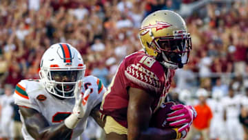 TALLAHASSEE OCTOBER 7: Wide receiver Auden Tate #18 of the Florida State Seminoles catches a pass for a touchdown over defensive back Dee Delaney #3 of the Miami Hurricanes during the second half of an NCAA football game at Doak S. Campbell Stadium on October 7, 2017 in Tallahassee, Florida. (Photo by Butch Dill/Getty Images)
