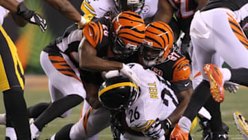 CINCINNATI, OH - DECEMBER 04: Geno Atkins #97 and Josh Shaw #26 of the Cincinnati Bengals tackle Le'Veon Bell #26 of the Pittsburgh Steelers during the first half at Paul Brown Stadium on December 4, 2017 in Cincinnati, Ohio. (Photo by John Grieshop/Getty Images)