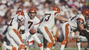 Boomer Esiason #7, Quarterback for the Cincinnati Bengals hands off the ball to #21 Running Back James Brooks during the American Football Conference Divisional Playoff game against the Los Angeles Raiders on 13 January 1991 at Los Angeles Memorial Coliseum, Los Angeles, California, United States.Raiders won the game 20 - 10 . (Photo by Mike Powell/Allsport/Getty Images)