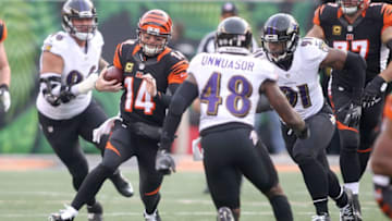 CINCINNATI, OH - JANUARY 1: Andy Dalton #14 of the Cincinnati Bengals runs the ball away from Matt Judon #91 of the Baltimore Ravens during the fourth quarter at Paul Brown Stadium on January 1, 2017 in Cincinnati, Ohio. Cincinnati defeated Baltimore 27-10. (Photo by John Grieshop/Getty Images)