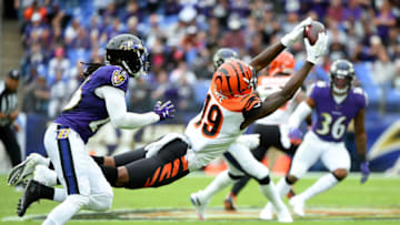 BALTIMORE, MD - OCTOBER 13: Auden Tate #19 of the Cincinnati Bengals makes a catch in front of Maurice Canady #26 of the Baltimore Ravens during the first half at M&T Bank Stadium on October 13, 2019 in Baltimore, Maryland. (Photo by Will Newton/Getty Images)