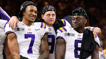 NEW ORLEANS, LA - JANUARY 13: Grant Delpit #7, Joe Burrow #9 and Patrick Queen #8 of the LSU Tigers celebrate after defeating the Clemson Tigers during the College Football Playoff National Championship held at the Mercedes-Benz Superdome on January 13, 2020 in New Orleans, Louisiana. (Photo by Jamie Schwaberow/Getty Images)