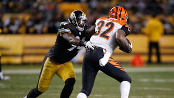 PITTSBURGH, PA - DECEMBER 28: Jeremy Hill #32 of the Cincinnati Bengals tries to get past Lawrence Timmons #94 of the Pittsburgh Steelers during the third quarter at Heinz Field on December 28, 2014 in Pittsburgh, Pennsylvania. (Photo by Gregory Shamus/Getty Images)