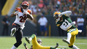 GREEN BAY, WI - SEPTEMBER 24: Joe Mixon #28 of the Cincinnati Bengals avoids a tackle by Ha Ha Clinton-Dix #21 of the Green Bay Packers during a game at Lambeau Field on September 24, 2017 in Green Bay, Wisconsin. The Packers defeated the Bengals in overtime 27-24. (Photo by Stacy Revere/Getty Images)