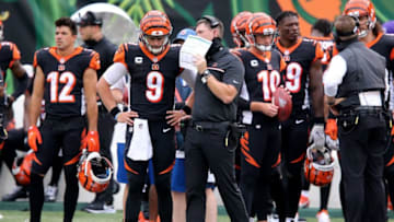 Cincinnati Bengals head coach Zac Taylor and Cincinnati Bengals quarterback Joe Burrow (9) talk during a timeout in the second quarter of a Week 1 NFL football game against the Los Angeles Chargers, Sunday, Sept. 13, 2020, at Paul Brown Stadium in Cincinnati.Los Angeles Chargers At Cincinnati Bengals Sept 13