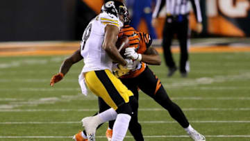 Cincinnati Bengals strong safety Vonn Bell (24) forces a fumble of Pittsburgh Steelers wide receiver JuJu Smith-Schuster (19) in the first quarter during an NFL Week 15 football game, Monday, Dec. 21, 2020, at Paul Brown Stadium in Cincinnati.Pittsburgh Steelers At Cincinnati Bengals Dec 21