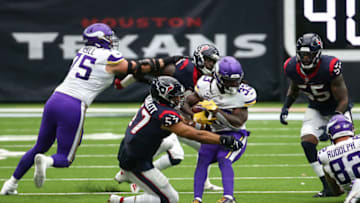 Oct 4, 2020; Houston, Texas, USA; Minnesota Vikings running back Dalvin Cook (33) runs the ball against Houston Texans outside linebacker Brennan Scarlett (57) during the second quarter at NRG Stadium. Mandatory Credit: Troy Taormina-USA TODAY Sports