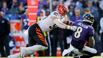 Baltimore Ravens quarterback Lamar Jackson (8) is brought down by Cincinnati Bengals defensive end Sam Hubbard (94) in the third quarter of the NFL Week 7 game between the Baltimore Ravens and the Cincinnati Bengals at M&T Bank Stadium in Baltimore on Sunday, Oct. 24, 2021. The Bengals moved into the top of the AFC North with a 41-17 win over the Ravens.Cincinnati Bengals At Baltimore Ravens Week 7
