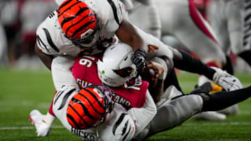 Aug 12, 2022; Cincinnati, Ohio, USA; Cincinnati Bengals defensive end Raymond Johnson III (69) and linebacker Clarence Hicks (50) sack Arizona Cardinals quarterback Jarrett Guarantano (16) in the fourth quarter at Paycor Stadium. Mandatory Credit: Sam Greene-USA TODAY Sports