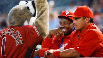 Jun 29, 2016; Phoenix, AZ, USA; Philadelphia Phillies catcher Carlos Ruiz (right) and first baseman Ryan Howard (center) joke with Arizona Diamondbacks mascot Baxter at Chase Field. Mandatory Credit: Mark J. Rebilas-USA TODAY Sports