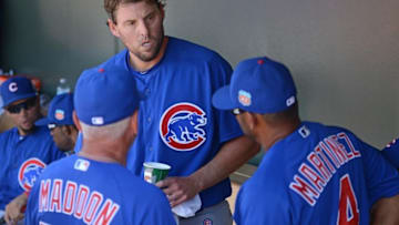Mar 16, 2016; Surprise, AZ, USA; Chicago Cubs starting pitcher John Lackey (C) talks with manager Joe Maddon (L) and bench coach Dave Martinez (4) after the fifth inning against the Kansas City Royals at Surprise Stadium. Mandatory Credit: Jake Roth-USA TODAY Sports