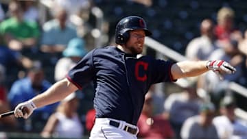 Mar 23, 2015; Goodyear, AZ, USA; Cleveland Indians first baseman Brandon Moss (44) reacts after hitting in the fifth against the Oakland Athletics during a spring training game at Goodyear Ballpark. Mandatory Credit: Rick Scuteri-USA TODAY Sports