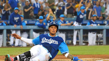LOS ANGELES, CA - AUGUST 24: Manny Machado #8 of the Los Angeles Dodgers is safe at home as he scores a run on a single by Matt Kemp #27 of the Los Angeles Dodgers in the first inning against the San Diego Padres at Dodger Stadium on August 24, 2018 in Los Angeles, California. Players are wearing special jerseys with their nicknames on them during Players' Weekend. (Photo by Jayne Kamin-Oncea/Getty Images)