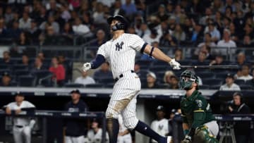 NEW YORK, NEW YORK - OCTOBER 03: Giancarlo Stanton #27 of the New York Yankees hits a solo home run in the eighth inning against the Oakland Athletics during the American League Wild Card Game at Yankee Stadium on October 03, 2018 in the Bronx borough of New York City. (Photo by Al Bello/Getty Images)