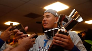 MILWAUKEE, WI - OCTOBER 20: Manny Machado #8 of the Los Angeles Dodgers celebrates with the Warren C. Giles Trophy in the locker room after defeating the Milwaukee Brewers in Game Seven to win the National League Championship Series at Miller Park on October 20, 2018 in Milwaukee, Wisconsin. (Photo by Jeff Roberson - Pool/Getty Images)