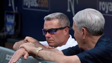 KANSAS CITY, MO - SEPTEMBER 05: Dayton Moore, left, general manager of the Kansas City Royals talks with owner and Chief Executive Officer David Glass during batting practice at Kauffman Stadium on September 5, 2015 in Kansas City, Missouri. (Photo by Reed Hoffmann/Getty Images)