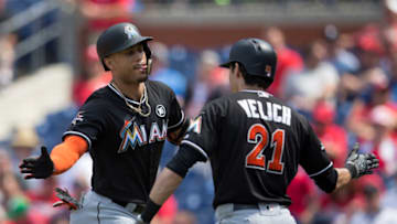 Giancarlo Stanton #27 of the Miami Marlins celebrates with Christian Yelich #21 (Photo by Mitchell Leff/Getty Images)