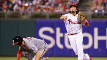 PHILADELPHIA, PA - SEPTEMBER 27: Freddy Galvis #13 of the Philadelphia Phillies turns a double play against Trea Turner #7 of the Washington Nationals in the top of the third inning at Citizens Bank Park on September 27, 2017 in Philadelphia, Pennsylvania. (Photo by Mitchell Leff/Getty Images)