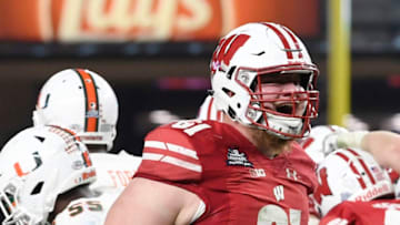 NEW YORK, NEW YORK - DECEMBER 27: Tyler Biadasz #61 of the Wisconsin Badgers reacts after the Badgers score a touchdown in the third quarter of the New Era Pinstripe Bowl against the Miami Hurricanes at Yankee Stadium on December 27, 2018 in the Bronx borough of New York City. (Photo by Sarah Stier/Getty Images)