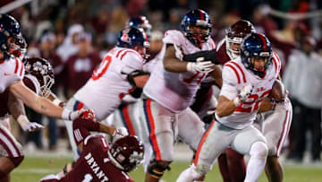 STARKVILLE, MS - NOVEMBER 23: Jordan Wilkins #22 of the Mississippi Rebels breaks through the Mississippi State Bulldogs line and carries in for a touchdown during the second half of an NCAA football game at Davis Wade Stadium on November 23, 2017 in Starkville, Mississippi. (Photo by Butch Dill/Getty Images)