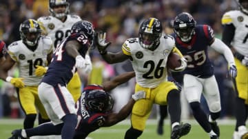 HOUSTON, TX - DECEMBER 25: Le'Veon Bell #26 of the Pittsburgh Steelers gives a stiff arm to Johnathan Joseph #24 of the Houston Texans in the first quarter at NRG Stadium on December 25, 2017 in Houston, Texas. (Photo by Tim Warner/Getty Images)