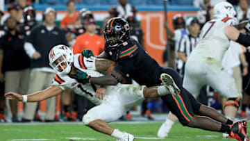 MIAMI GARDENS, FL - NOVEMBER 04: Josh Jackson #17 of the Virginia Tech Hokies is tackled by Chad Thomas #9 of the Miami Hurricanes during a game at Hard Rock Stadium on November 4, 2017 in Miami Gardens, Florida. (Photo by Mike Ehrmann/Getty Images)