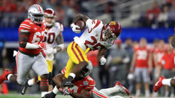 ARLINGTON, TX - DECEMBER 29: Ronald Jones II #25 of the USC Trojans runs the ball against Jordan Fuller #4 of the Ohio State Buckeyes in the third quarter during the Goodyear Cotton Bowl at AT&T Stadium on December 29, 2017 in Arlington, Texas. (Photo by Ronald Martinez/Getty Images)