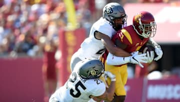 LOS ANGELES, CA - OCTOBER 08: Darreus Rogers #1 of the USC Trojans is brought down after his catch by Ryan Moeller #25 and Isaiah Oliver #26 of the Colorado Buffaloes during the second quarter at Los Angeles Memorial Coliseum on October 8, 2016 in Los Angeles, California. (Photo by Harry How/Getty Images)