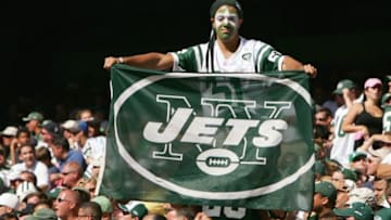 EAST RUTHERFORD, NJ - SEPTEMBER 23: A fan of the New York Jets holds up a Jets flag during the game against the Miami Dolphins on September 23, 2007 at Giants Stadium in East Rutherford, New Jersey. The Jets defeated the Dolphins 31-28. (Photo by Al Bello/Getty Images)