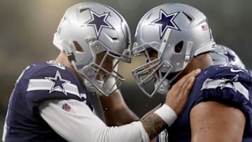 ARLINGTON, TEXAS - DECEMBER 15: Dak Prescott #4 of the Dallas Cowboys celebrates with La'el Collins #71 of the Dallas Cowboys after the Dallas Cowboys scored a touchdown against the Los Angeles Rams in the second quarter at AT&T Stadium on December 15, 2019 in Arlington, Texas. (Photo by Tom Pennington/Getty Images)