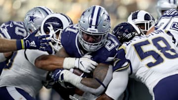 ARLINGTON, TEXAS - DECEMBER 15: Ezekiel Elliott #21 of the Dallas Cowboys carries the ball against Cory Littleton #58 of the Los Angeles Rams in the first half at AT&T Stadium on December 15, 2019 in Arlington, Texas. (Photo by Tom Pennington/Getty Images)