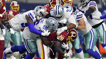 ARLINGTON, TEXAS - NOVEMBER 22: Adrian Peterson #26 of the Washington Redskins gets smothered by Maliek Collins #96, Randy Gregory #94, and Caraun Reid #51 of the Dallas Cowboys in the first quarter of a football game at AT&T Stadium on November 22, 2018 in Arlington, Texas. (Photo by Richard Rodriguez/Getty Images)