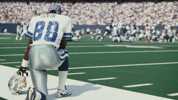 Michael Irvin #88, wide receiver for the Dallas Cowboys kneels on the sideline watching the action during the National Football Conference East game against the New York Giants on 5 October 1997 at the Giants Stadium, East Rutherford, New Jersey, United States. Giants won 17 - 20 . (Photo by Al Bello/Allsport/Getty Images)