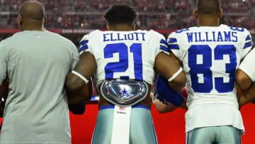 GLENDALE, AZ - SEPTEMBER 25: Running back Ezekiel Elliott #21 of the Dallas Cowboys and wide receiver Terrance Williams #83 link arms during the National Anthem before the start of the NFL game against the Arizona Cardinals at University of Phoenix Stadium on September 25, 2017 in Glendale, Arizona. (Photo by Jennifer Stewart/Getty Images)