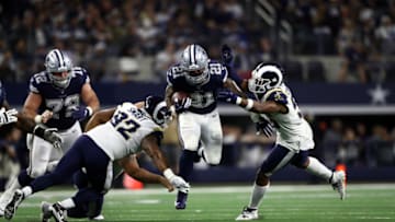 ARLINGTON, TEXAS - DECEMBER 15: Ezekiel Elliott #21 of the Dallas Cowboys runs the ball against Dante Fowler #56 of the Los Angeles Rams in the second half at AT&T Stadium on December 15, 2019 in Arlington, Texas. (Photo by Ronald Martinez/Getty Images)
