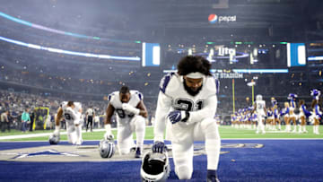 ARLINGTON, TEXAS - NOVEMBER 29: Ezekiel Elliott #21 of the Dallas Cowboys kneels in the endzone before a game against the New Orleans Saints at AT&T Stadium on November 29, 2018 in Arlington, Texas. (Photo by Ronald Martinez/Getty Images)