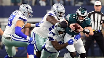 ARLINGTON, TEXAS - DECEMBER 09: Randy Gregory #94, Maliek Collins #96, and Tyrone Crawford #98 of the Dallas Cowboys sack Carson Wentz #11 of the Philadelphia Eagles in the first quarter at AT&T Stadium on December 09, 2018 in Arlington, Texas. (Photo by Richard Rodriguez/Getty Images)