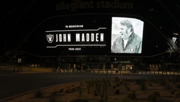 LAS VEGAS, NEVADA - DECEMBER 28: A tribute to former Raiders head coach, Pro Football Hall of Fame member and broadcaster John Madden is displayed on the side of Allegiant Stadium, home of the Las Vegas Raiders, after news of his death at the age of 85 on December 28, 2021 in Las Vegas, Nevada. Madden coached the Oakland Raiders for 10 seasons and won the team's first championship with a win over the Minnesota Vikings in Super Bowl XI in 1977. Owner and managing general partner Mark Davis of the Las Vegas Raiders lit the Al Davis Memorial Torch inside the stadium before the organization turned off all the exterior lights, except for the memorial message, in honor of Madden. (Photo by Ethan Miller/Getty Images)