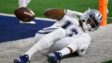 ARLINGTON, TEXAS - JANUARY 02: Michael Gallup #13 of the Dallas Cowboys holds his leg after catching the ball for a touchdown during the second quarter against the Arizona Cardinals at AT&T Stadium on January 02, 2022 in Arlington, Texas. (Photo by Richard Rodriguez/Getty Images)