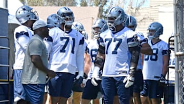 OXNARD, CA - AUGUST 03: Offensive tackle La'el Collins #71 and offensive tackle Tyron Smith #77 of the Dallas Cowboys wait to enter the field for training camp at River Ridge Complex on August 3, 2021 in Oxnard, California. (Photo by Jayne Kamin-Oncea/Getty Images)