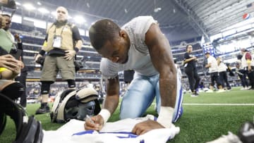 ARLINGTON, TEXAS - OCTOBER 02: Micah Parsons #11 of the Dallas Cowboys signs his jersey after his team's 25-10 win against the Washington Commanders at AT&T Stadium on October 02, 2022 in Arlington, Texas. (Photo by Wesley Hitt/Getty Images)